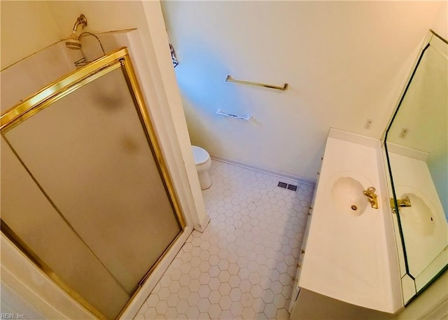 bathroom with vanity, a stall shower, tile patterned flooring, and toilet