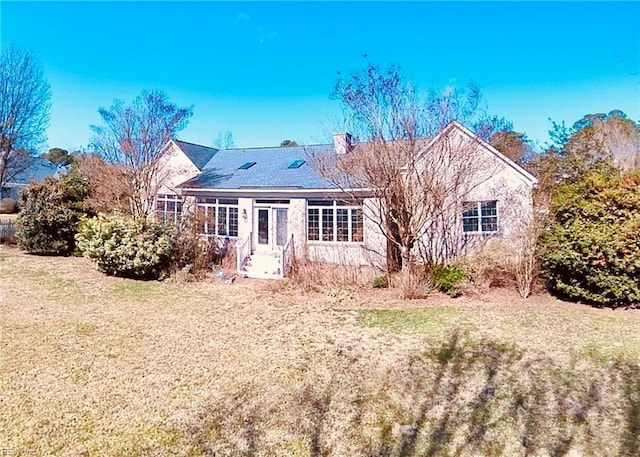 rear view of property with a yard