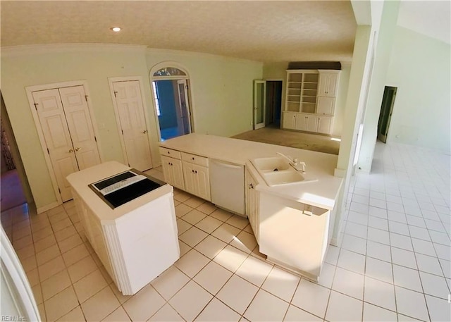 kitchen featuring light countertops, dishwasher, a sink, and light tile patterned floors