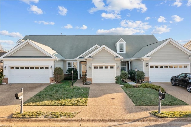 view of front of property with concrete driveway, brick siding, an attached garage, and a front yard