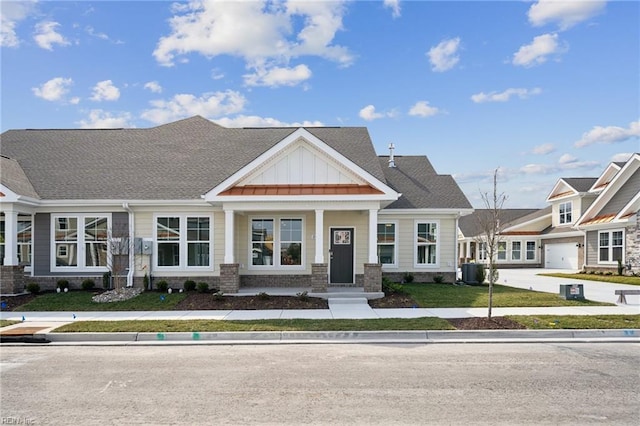 view of front of property with central AC and board and batten siding