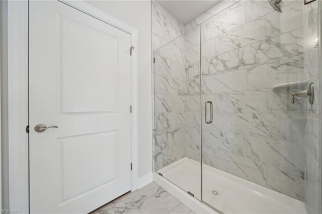 full bathroom with marble finish floor and a shower stall