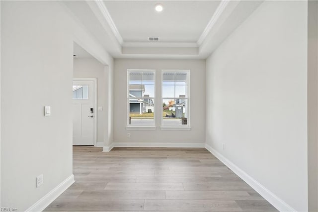 interior space featuring ornamental molding, light wood-type flooring, a wealth of natural light, and baseboards