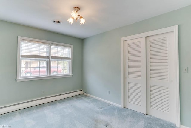 unfurnished bedroom with visible vents, baseboards, carpet, a baseboard heating unit, and a closet