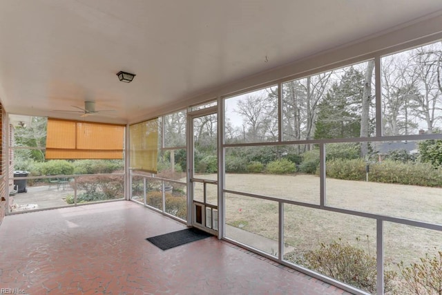 unfurnished sunroom featuring a ceiling fan