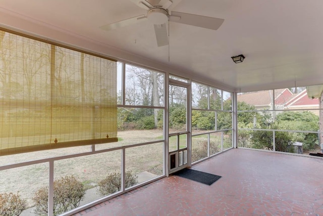 unfurnished sunroom featuring ceiling fan