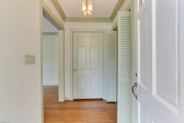 interior space featuring ornamental molding and light wood-style floors