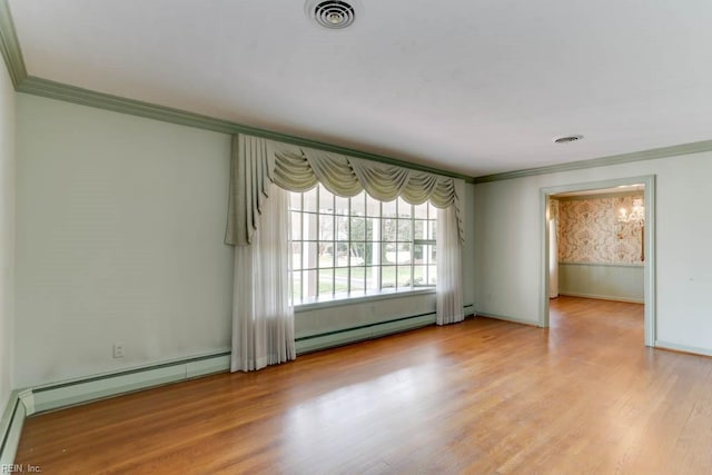 spare room featuring ornamental molding, a baseboard radiator, visible vents, and light wood-style floors