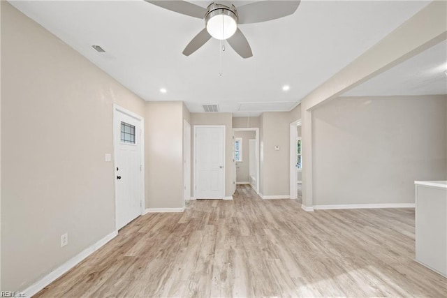 unfurnished room with light wood-style flooring, visible vents, ceiling fan, and baseboards