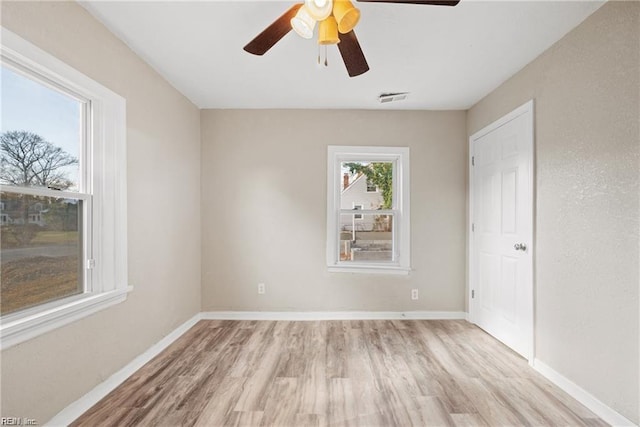 unfurnished bedroom with light wood-type flooring, baseboards, visible vents, and ceiling fan