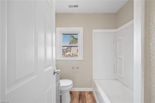 bathroom featuring baseboards, visible vents, toilet, and wood finished floors