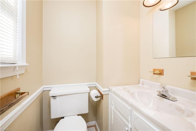 half bath featuring toilet and vanity