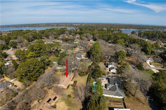 birds eye view of property featuring a water view and a view of trees