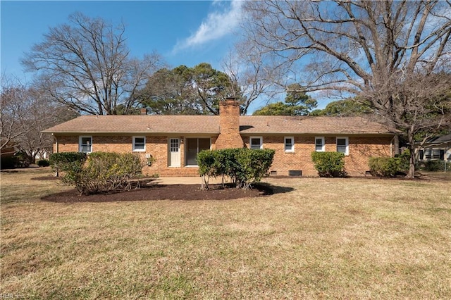 back of house with crawl space, a lawn, a chimney, and brick siding