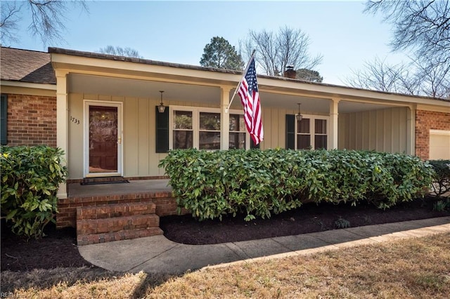 single story home featuring brick siding, covered porch, an attached garage, and a shingled roof