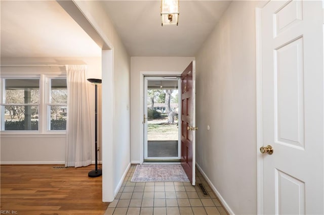 foyer featuring tile patterned flooring and baseboards