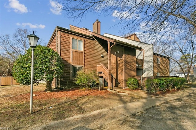 view of property exterior with a chimney