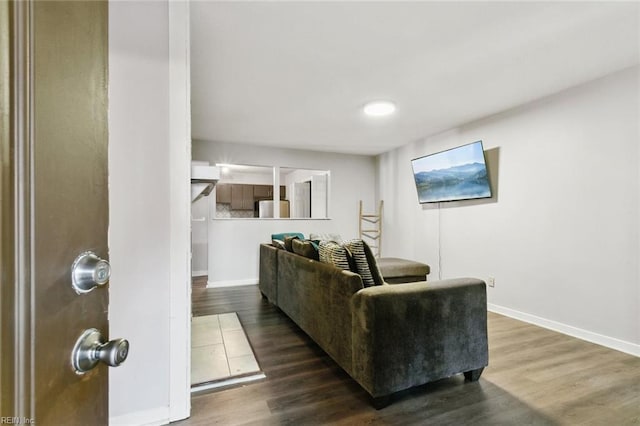 living room featuring baseboards and wood finished floors