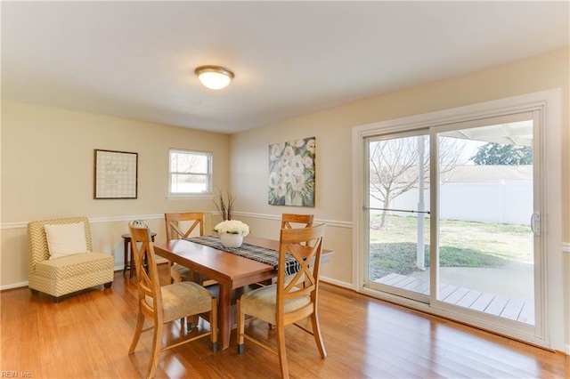 dining room with light wood-type flooring and baseboards