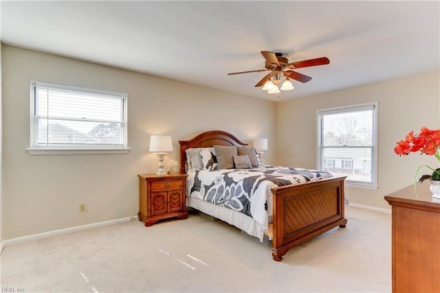 bedroom featuring light carpet, ceiling fan, and baseboards