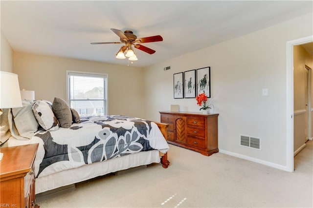 bedroom with baseboards, a ceiling fan, visible vents, and light colored carpet