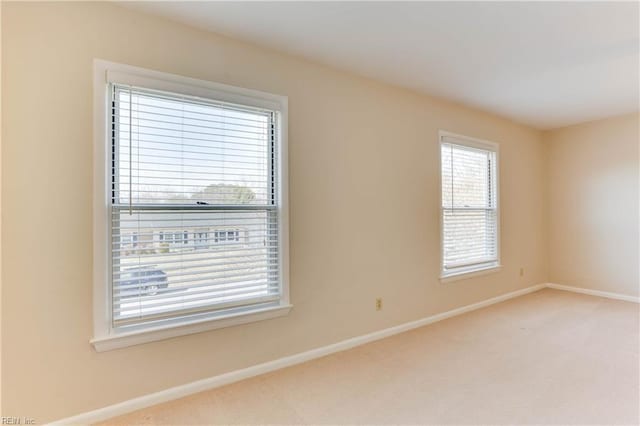 empty room with baseboards and carpet flooring