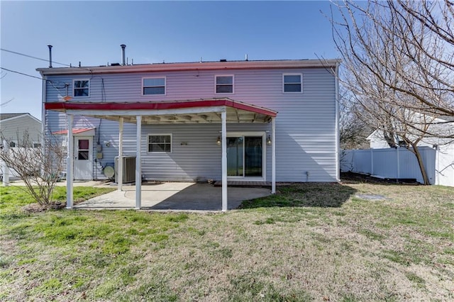 rear view of house featuring central AC unit, a patio area, fence, and a lawn