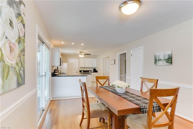 dining room with light wood finished floors, a ceiling fan, visible vents, and recessed lighting