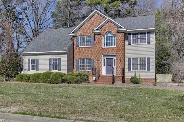 colonial inspired home featuring a front yard and fence