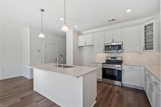 kitchen with visible vents, decorative backsplash, appliances with stainless steel finishes, white cabinetry, and a sink