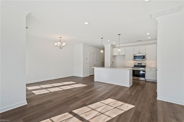 kitchen featuring recessed lighting, a sink, white cabinets, appliances with stainless steel finishes, and dark wood-style floors