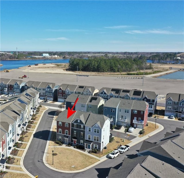 drone / aerial view with a residential view and a water view