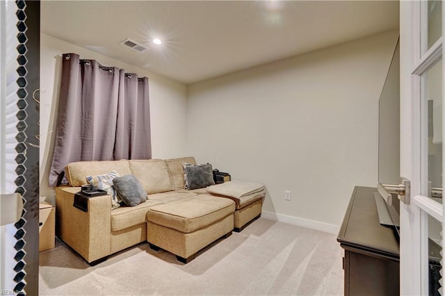 living area with recessed lighting, visible vents, light carpet, and baseboards