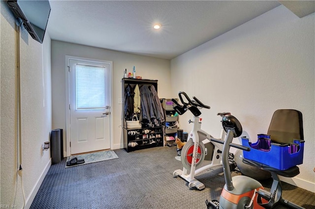 workout room with carpet floors and baseboards