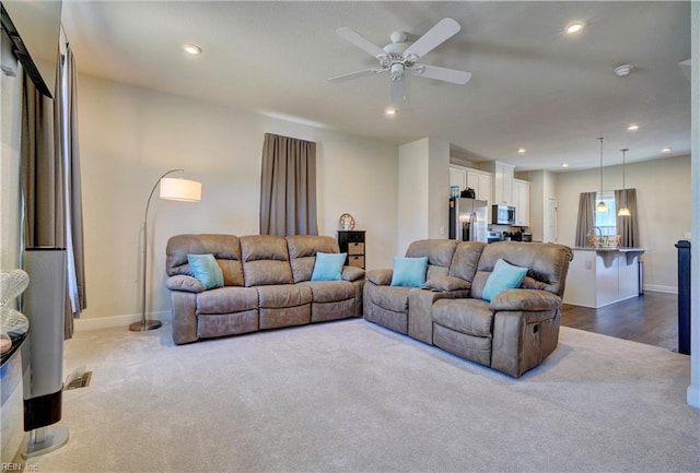 living area with baseboards, dark colored carpet, a ceiling fan, and recessed lighting