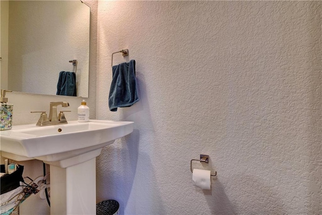 bathroom with a sink and a textured wall