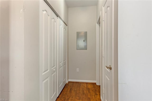 hall with electric panel, baseboards, and wood finished floors