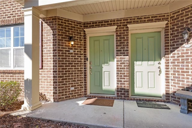 property entrance with brick siding