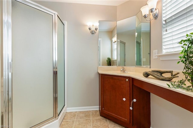 full bath featuring a stall shower, tile patterned flooring, baseboards, and vanity