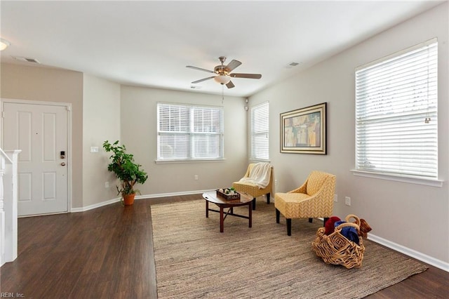 sitting room with visible vents, baseboards, and wood finished floors