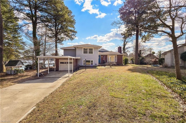 view of front of house featuring concrete driveway, a front lawn, and a chimney