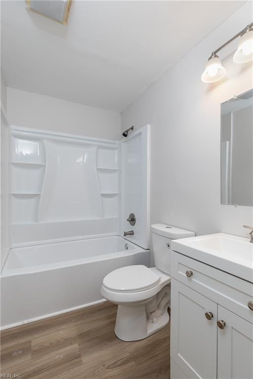 full bath with toilet, vanity, wood finished floors, and shower / bathing tub combination