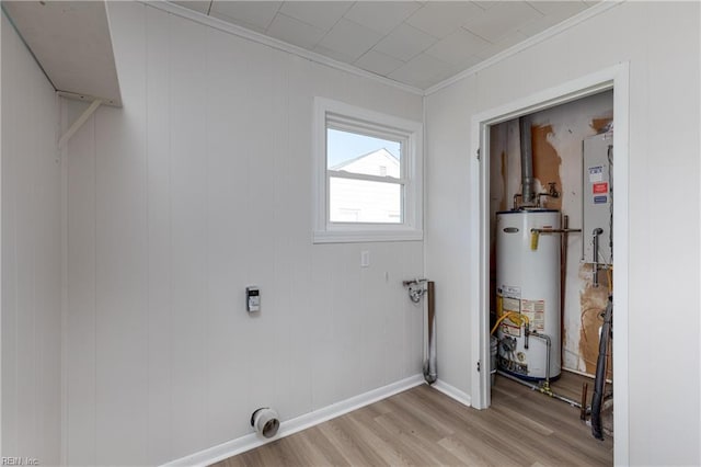 laundry room featuring light wood finished floors, water heater, ornamental molding, electric dryer hookup, and baseboards