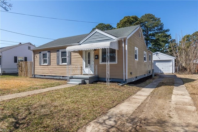 bungalow with driveway, a detached garage, fence, an outdoor structure, and a front yard