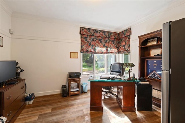 home office featuring ornamental molding, baseboards, and wood finished floors