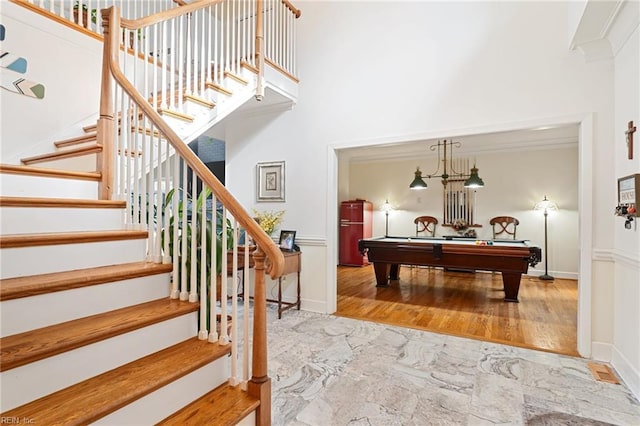 recreation room featuring marble finish floor, billiards, a towering ceiling, and baseboards