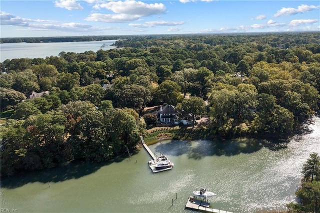 drone / aerial view with a water view and a wooded view