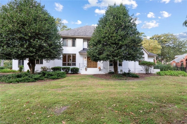 view of front of house featuring a front lawn and stucco siding