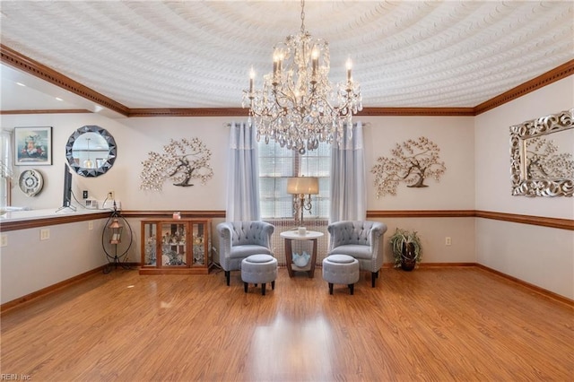 sitting room with crown molding, wood finished floors, and baseboards