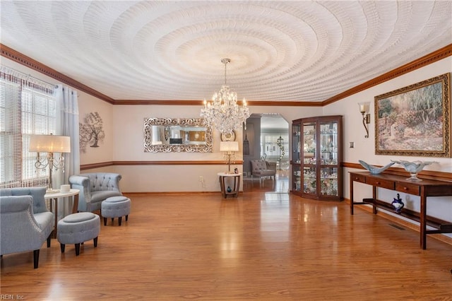 living area featuring a chandelier, arched walkways, visible vents, and wood finished floors